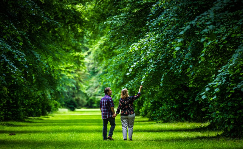 Couple surrounded by bluebells at Westonbirt Arboretum